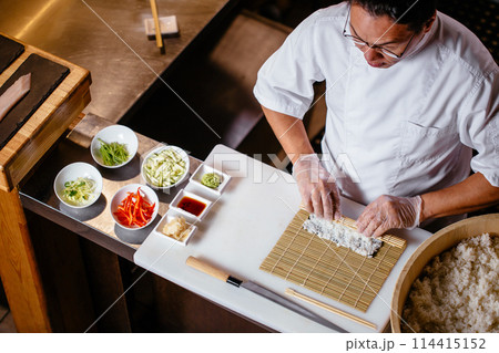 man in white uniform making the roll man in white uniform making the roll 114415152