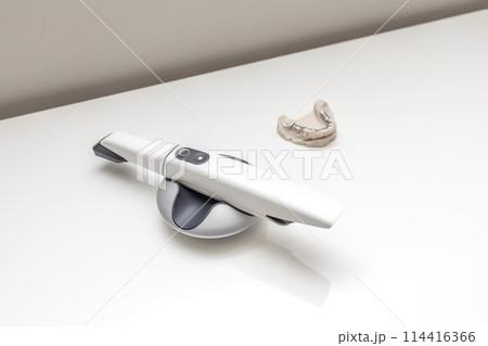 3D Intraoral Teeth Scanner For Imaging Tooth and Metal Frame Lower Partial Denture, Cobalt Chrome Dental Plate, Bridge Printed By 3d Printer on Table. Dental Equipment, Device, Dentistry. Horizontal. 3D Intraoral Teeth Scanner For Imaging Tooth and Metal Frame Lower Partial Denture, Cobalt Chrome Dental Plate, Bridge Printed By 3d Printer on Table. Dental Equipment, Device, Dentistry. Horizontal. 114416366