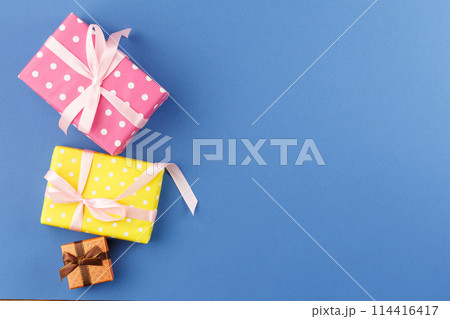 Paper wrapped gifts with satin ribbons. Paper wrapped gifts with satin ribbons. 114416417