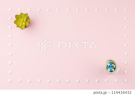 Pills and flower on a pink table. Pills and flower on a pink table. 114416432