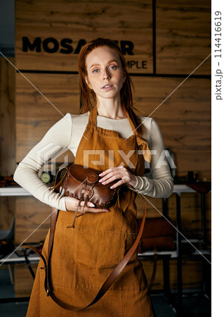 skilled craftswoman shows a master class of sewing bags, wallets skilled craftswoman shows a master class of sewing bags, wallets 114416619