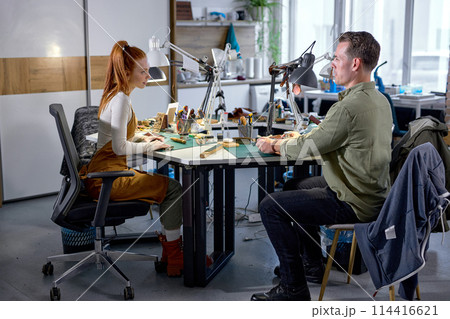 excited enthusiastic young people make handcrafted Wallets 114416621