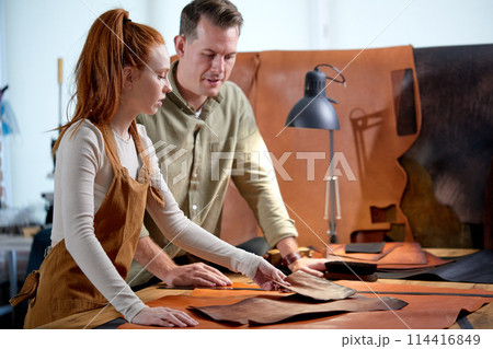 ginger girl teaching her male student to sew handmade goods ginger girl teaching her male student to sew handmade goods 114416849