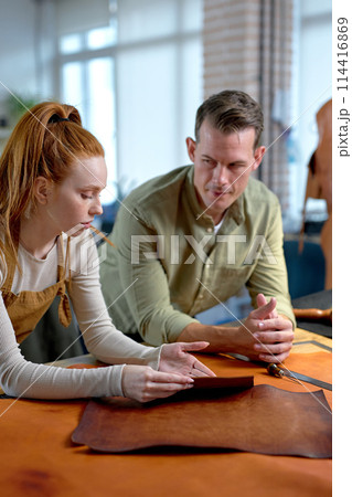 serious man and ginger woman thinking how to add a unique design serious man and ginger woman thinking how to add a unique design 114416869