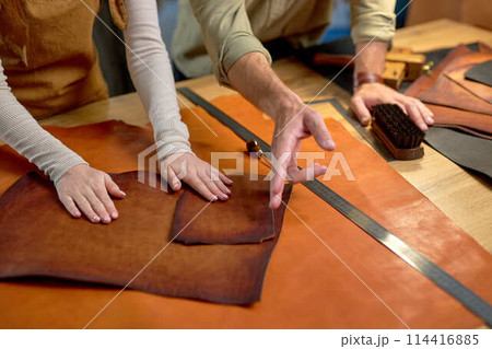 man pointing to cut leather man pointing to cut leather 114416885