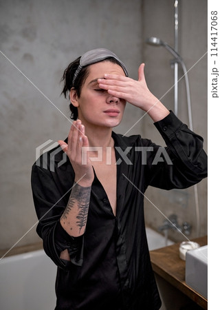 young elegant man using cream young elegant man using cream 114417068