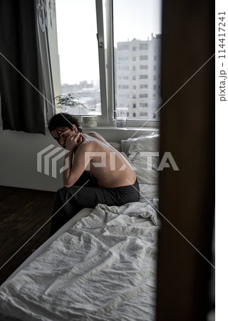 sleepy depressed man sits indoors sleepy depressed man sits indoors 114417241