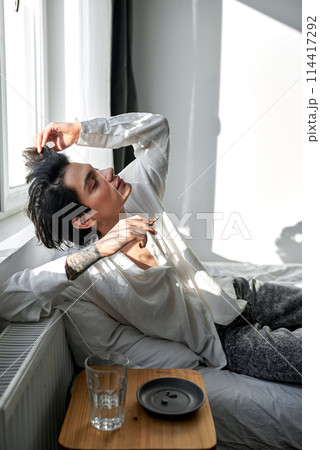 young man taking drugs at home 114417292