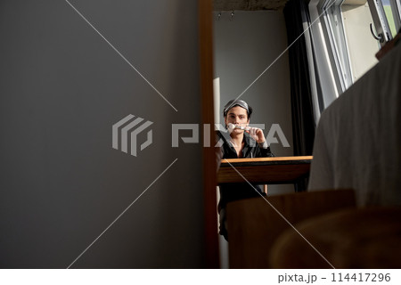 pensive serious man holding brush sits on the chair looks at the camera pensive serious man holding brush sits on the chair looks at the camera 114417296