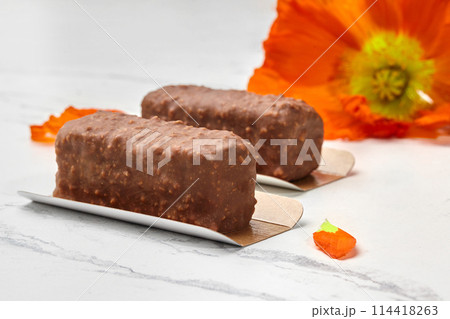 Chocolate and nut mini loaf cakes with orange poppy flower 114418263