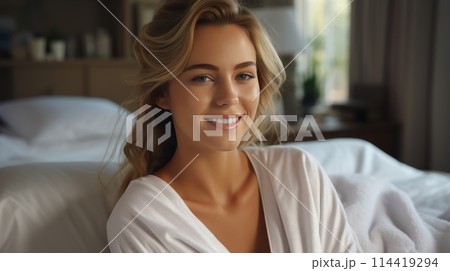 Woman in White Robe Sitting on Bed 114419294