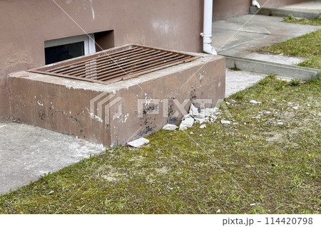 Basement opens in the building of house has window is located below ground level. The window is covered with a lattice of steel rods to protect any entry into the basement Basement opens in the building of house has window is located below ground level. The window is covered with a lattice of steel rods to protect any entry into the basement 114420798