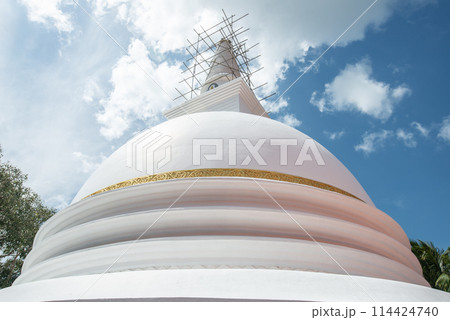 The large white stupa in Sri Maha Bodhi Viharaya temple in Kandy city, Sri Lanka. Stupa is a ceremonial burial mound used for the veneration of Buddhist saints and relics. The large white stupa in Sri Maha Bodhi Viharaya temple in Kandy city, Sri Lanka. Stupa is a ceremonial burial mound used for the veneration of Buddhist saints and relics. 114424740