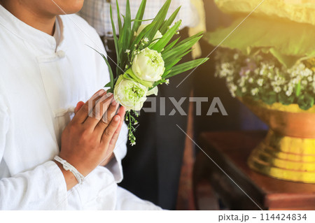 hands praying in make merrit day of Thai people with flowers and lotus hands praying in make merrit day of Thai people with flowers and lotus 114424834