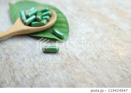 Green herbal capsules from herb for healthy eating in daily life Green herbal capsules from herb for healthy eating in daily life 114424847