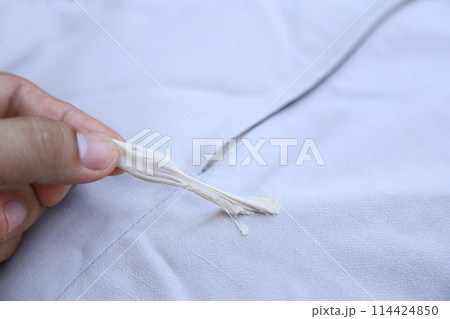 hand pulling gum stick on pants from accident in daily life. dirty stain for cleaning concept. hand pulling gum stick on pants from accident in daily life. dirty stain for cleaning concept. 114424850