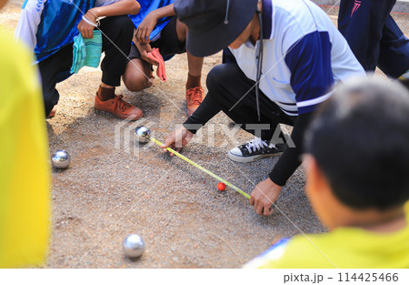 referee measure distance in playing Petanque in sportday of school 114425466