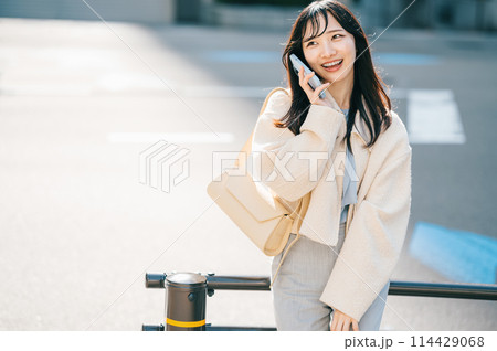街で電話をする若い女性 114429068