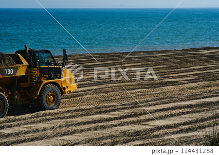 a large dump truck on the beach a large dump truck on the beach 114431288