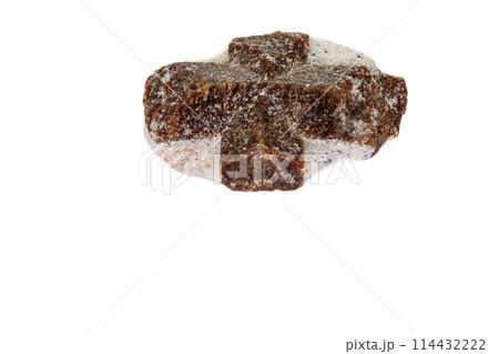 macro mineral stone Staurolite on a white background macro mineral stone Staurolite on a white background 114432222