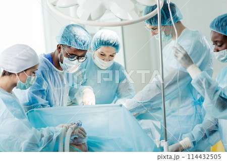 multiracial surgeons treating problems with the musculoskeletal system. multiracial surgeons treating problems with the musculoskeletal system. 114432505