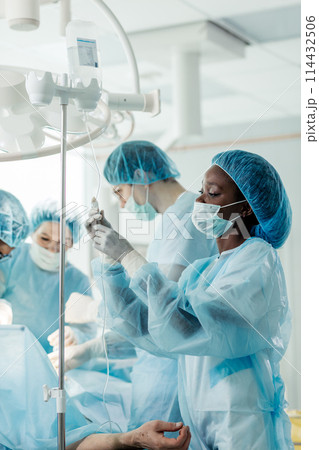 talented skilled doctors perform a successful procedure. 114432506