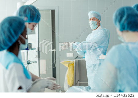 leader of team in uniform having a break during the surgery 114432622