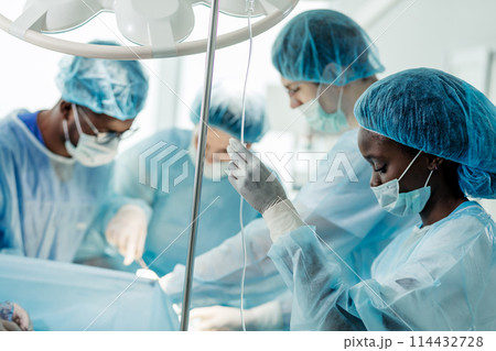 Young awesome female anesthesiologist puts the dropper in hospital room 114432728
