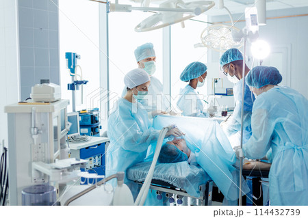 team of doctors repair and diagnose internal problems. 114432739