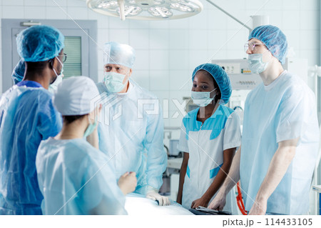 skilled experienced doctor teaching interns skilled experienced doctor teaching interns 114433105
