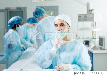 Young tired nurse in cap and face mask Young tired nurse in cap and face mask 114433112