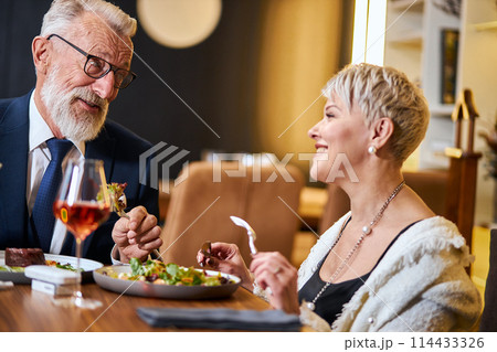 Senior couple in love having dinner in elegant restaurant Senior couple in love having dinner in elegant restaurant 114433326