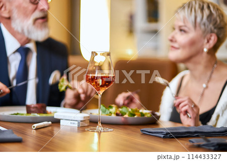 Happy modern mature couple celebrating in elegant restaurant Happy modern mature couple celebrating in elegant restaurant 114433327