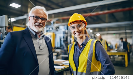 An experienced engineer and his young female apprentice are posi 114436142