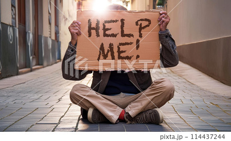 Homeless Man Sitting in the Street Holding a Cardboard Sign that Says Help Me! - Generative Ai 114437244