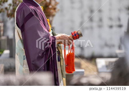 永代供養墓の前で読経するお坊さん 114439519