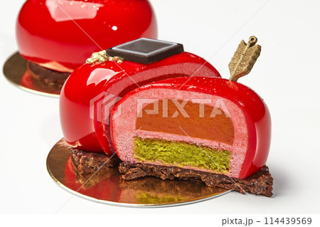 Detailed view of red glazed heart-shaped pastry with golden arrow Detailed view of red glazed heart-shaped pastry with golden arrow 114439569