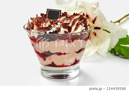 Tempting cherry trifle with chocolate, whipped cream and flower Tempting cherry trifle with chocolate, whipped cream and flower 114439598