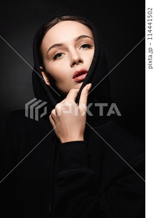 portrait of beautiful young woman in hood. pretty girl portrait of beautiful young woman in hood. pretty girl 114441502