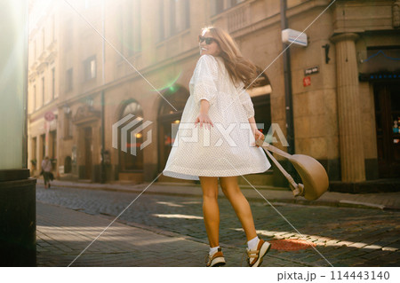 Young beautiful woman walking the streets of an Italian town. Travel and tourism concept. Young beautiful woman walking the streets of an Italian town. Travel and tourism concept. 114443140