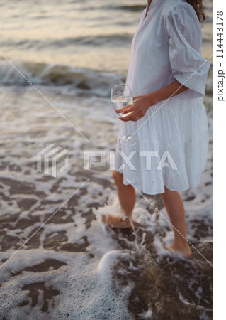 Stylish woman in elegant white dress posing near the sea. People, freedom, lifestyle, travel. Stylish woman in elegant white dress posing near the sea. People, freedom, lifestyle, travel. 114443178
