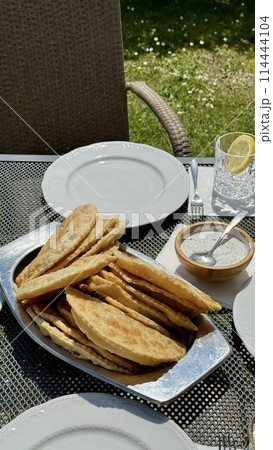 At the picnic, delicious hot chebureks with meat are prepared for tasting At the picnic, delicious hot chebureks with meat are prepared for tasting 114444104