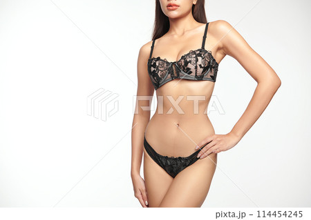 Confident beautiful young asian woman posing in black lingerie on white background, Perfect body, 114454245