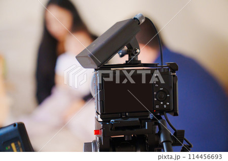 A professional camera on the blurred background of a banquet hall. A professional camera on the blurred background of a banquet hall. 114456693