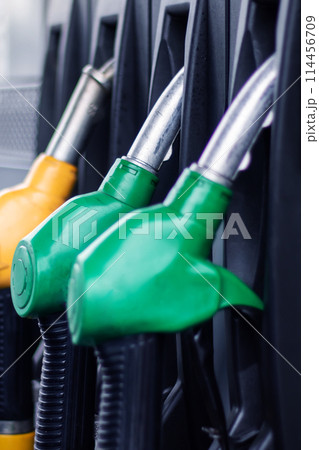 A collection of gas pumps in electric blue, plastic, carmine, and wire A collection of gas pumps in electric blue, plastic, carmine, and wire 114456709