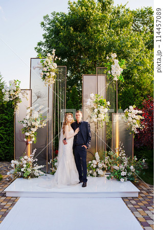 The bride and groom at the wedding ceremony venue The bride and groom at the wedding ceremony venue 114457089