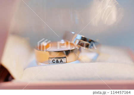Wedding rings of a combination gold with the letters of bride and groom's names. Wedding rings of a combination gold with the letters of bride and groom's names. 114457164