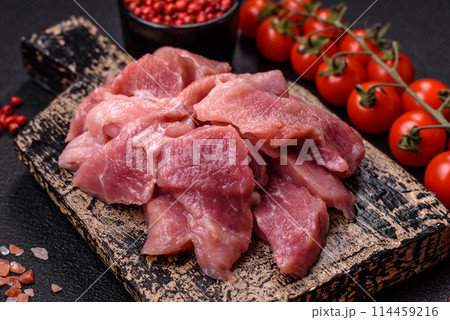 Slices of raw pork or turkey meat with salt, spices and herbs 114459216