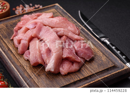 Slices of raw pork or turkey meat with salt, spices and herbs 114459228