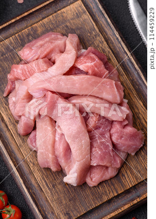 Slices of raw pork or turkey meat with salt, spices and herbs Slices of raw pork or turkey meat with salt, spices and herbs 114459229